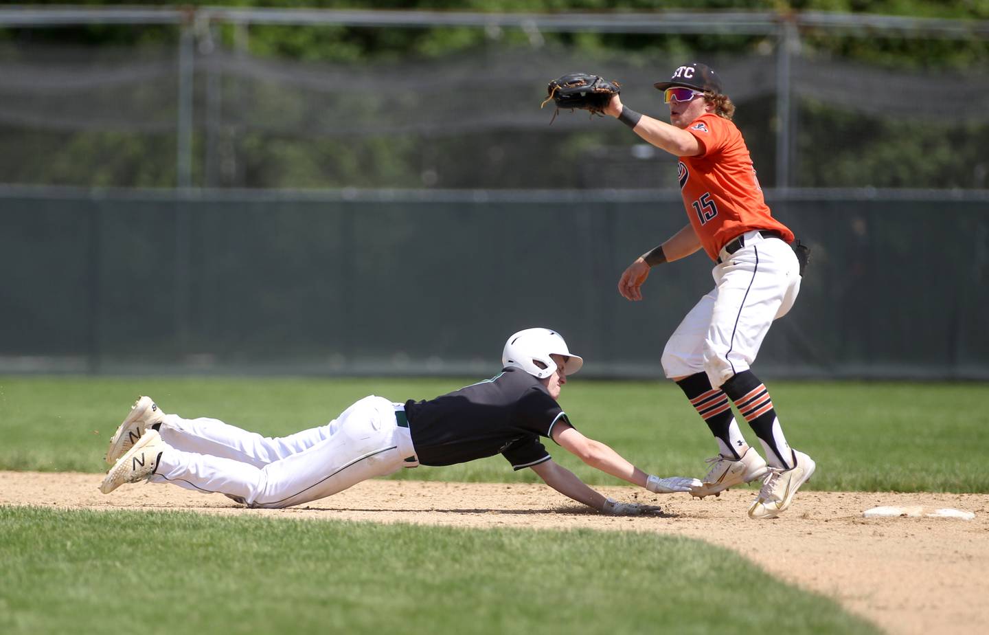 Glenbard West’s Danny Nash slides back into second base as St. Charles East’s Seth Winkler gets the out during the Class 4A Glenbard West Regional final in Glen Ellyn on Saturday, May 28, 2022.