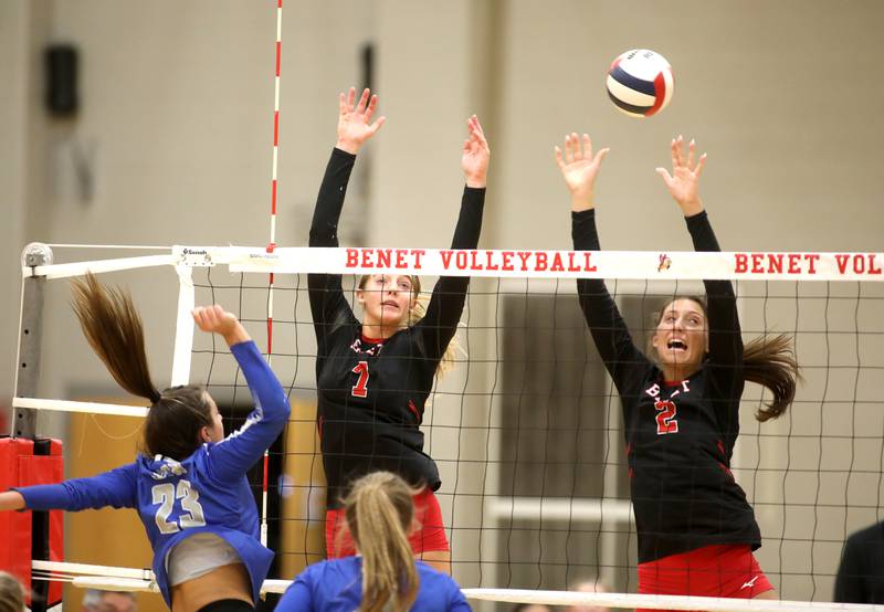 Benet’s Audrey Asleson (left) and Gabby Stasys attempt a block from St. Charles North’s Haley Burgdorf during a game on Monday, Oct. 7, 2024 at Benet in Lisle.