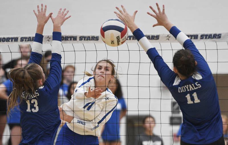 St. Charles North’s Kayla Davern gets her shot between Rosary’s Jessica Hirner and Megan Lanan, right, in a girls volleyball game in St. Charles on Monday, August 22, 2022.