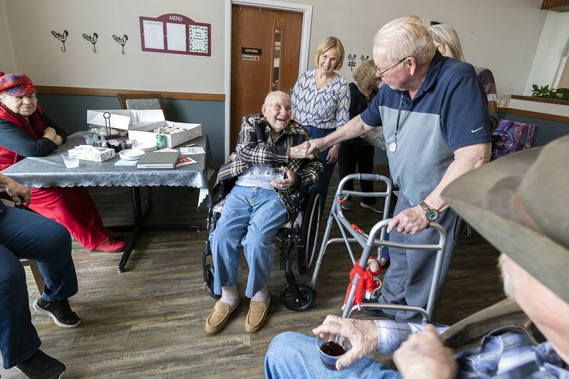 Liberty Court resident Arlen McClain shakes hands with Bob Chamberlin on his birthday Friday, March 21, 2025, in Dixon.
