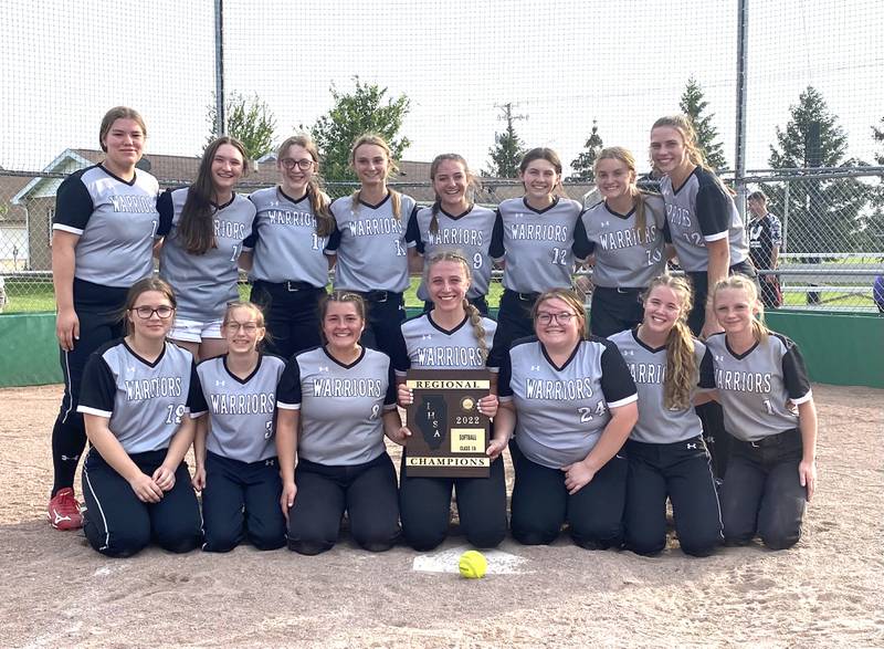 The Woodland/Flanagan-Cornell softball team poses at home plate with its freshly won Class 1A Dwight Regional championship plaque Friday, May 20, 2022.