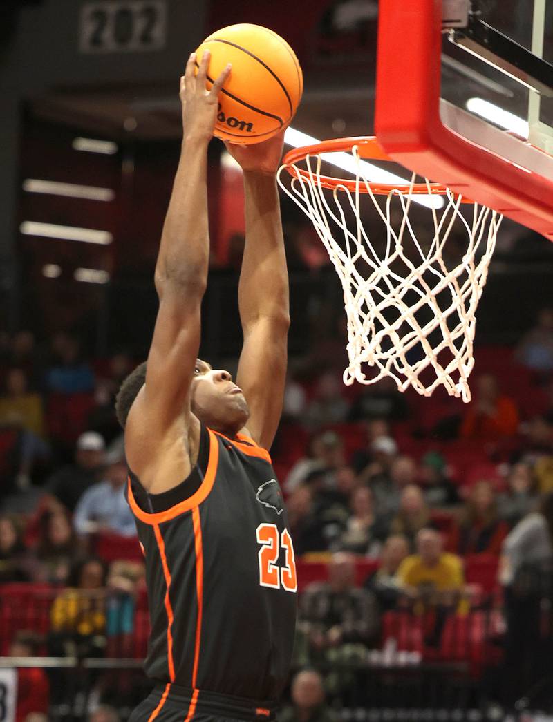 DeKalb's Davon Grant dunks the ball in front of Sycamore's Unique Shaw during their game Friday, Jan. 31, 2025, in the FNBO Challenge in the Convocation Center at Northern Illinois University in DeKalb.