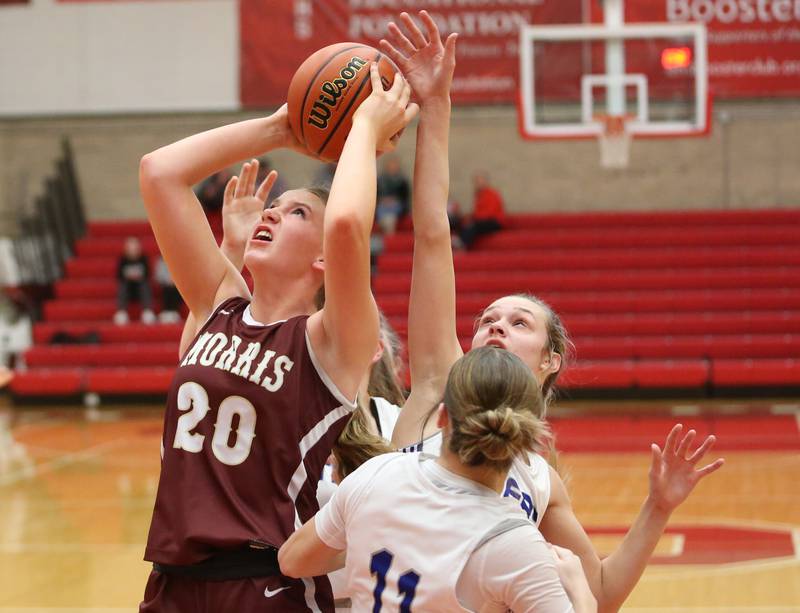 Morris's Landrie Callahan eyes the hoop as Princeton's Keighley Davis and Makayla Hecht defend during the Lady Pirate Holiday Tournament on Wednesday, Dec. 20, 2023 in Kingman Gym.