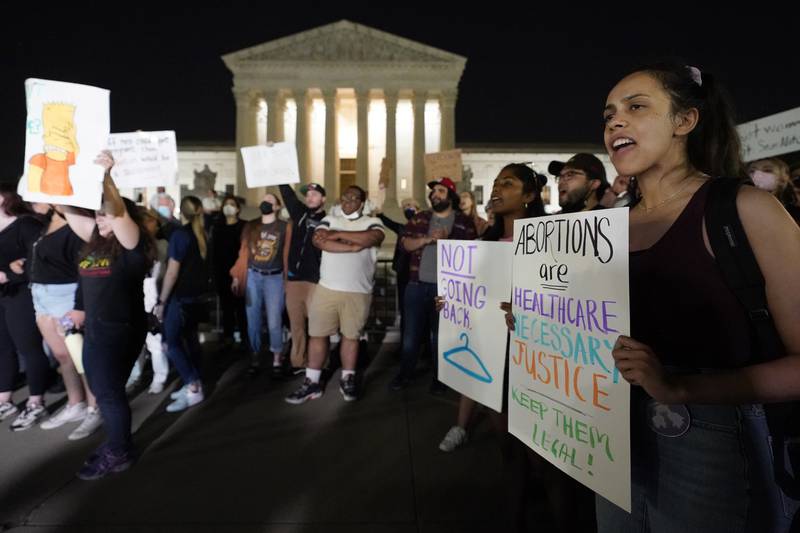 A crowd of people gather outside the Supreme Court, early Tuesday, May 3, 2022 in Washington. A draft opinion circulated among Supreme Court justices suggests that earlier this year a majority of them had thrown support behind overturning the 1973 case Roe v. Wade that legalized abortion nationwide, according to a report published Monday night in Politico. It's unclear if the draft represents the court's final word on the matter. The Associated Press could not immediately confirm the authenticity of the draft Politico posted, which if verified marks a shocking revelation of the high court's secretive deliberation process, particularly before a case is formally decided. (AP Photo/Alex Brandon)