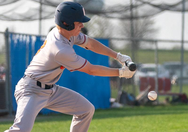 Oswego’s Will Pavlick (8) bunts the ball against Oswego East during a baseball game at Oswego East High School on Tuesday, May 10, 2022.
