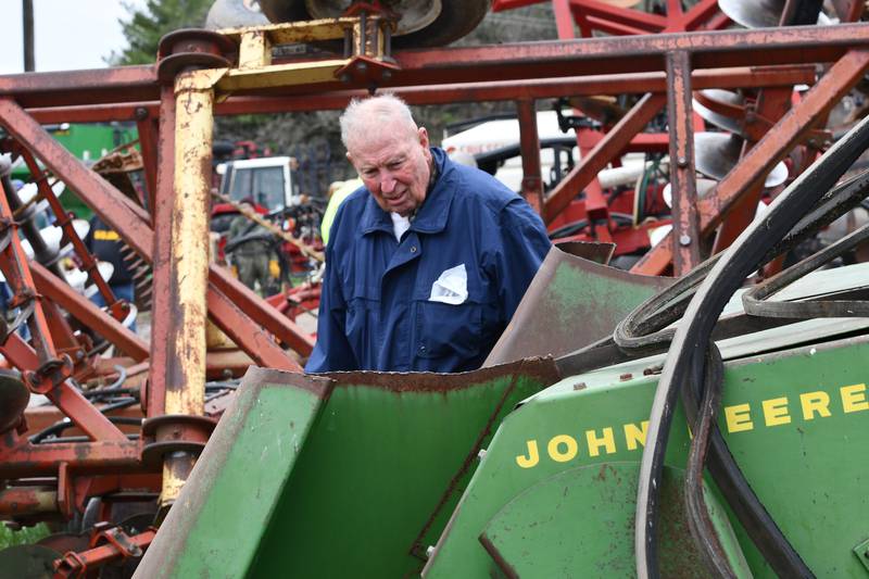 Robert Law, a retired farmer from Mount Carroll, looks at one of the older pieces of farm equipment up for auction at the Spring Hazelhurst Consignment Sale on Saturday, April 4, 2026.
