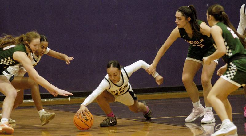 Nia Harris dives for a loose ball. The Sterling Golden Warriors played  the Lincoln Railsplitters in the Dixon Holiday Tournament at Reagan Middle School in Dixon on Friday, December 26th, 2025.
