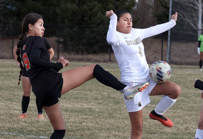 Plainfield East's Genesis Barrera (left) and Sycamore's Karyme Jimenez try to win possession after a throw in during their game Tuesday, March 25, 2025, in the Barb Fest tournament at DeKalb High School.