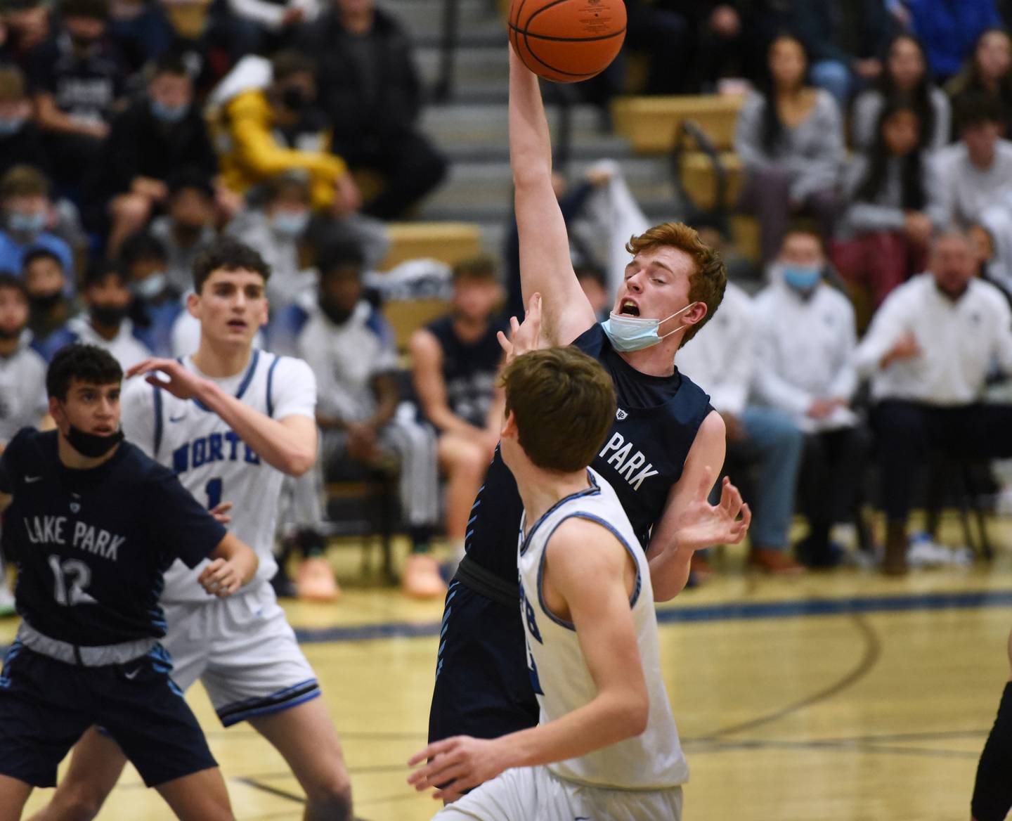 Lake Park's Thomas Rochford pulls down one of his multiple rebounds during Tuesday's boys basketball game at St. Charles North.