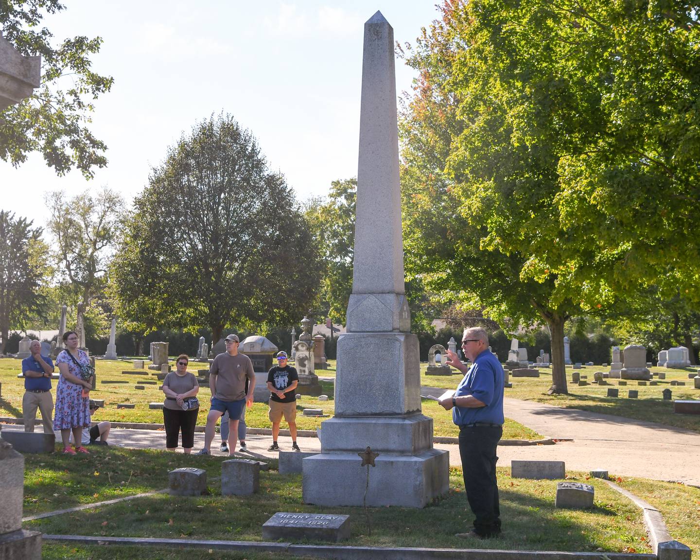 Community members listen to Harlan Hawkins talk about H.C. Whittemore during the Etched in Stone cemetery walk on Sunday Oct. 5, 2025, held at Elmwood cemetery in Sycamore.