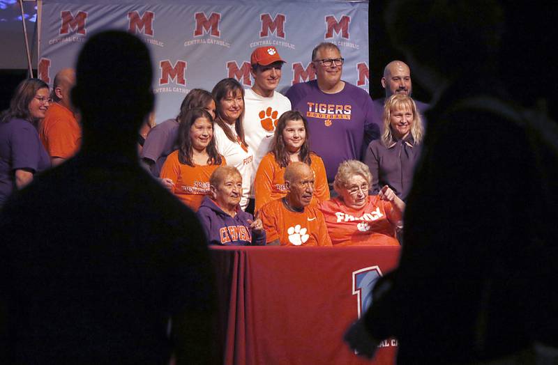 Christian Bentancur poses for pictures with family members Friday, Jan. 13, 2023, after he announced that he will attend Clemson University to play Division I football, at Marian Central High School. Bentancur, a highly recruited tight-end, narrowed his section down to Clemson from his final three colleges. The other two colleges were Ohio State and Oregon universities.