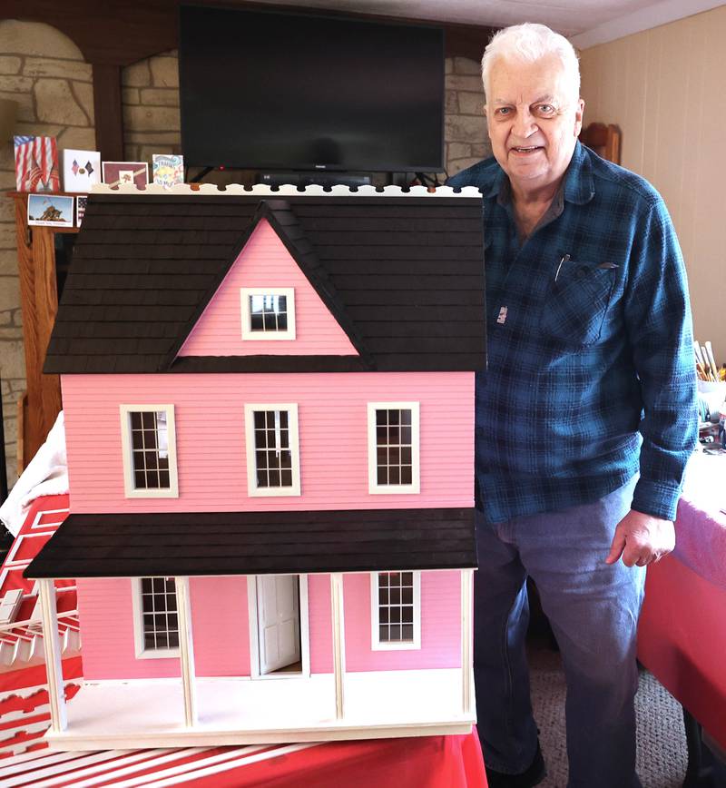 Sycamore resident Lee Newtson with a dollhouse Thursday, March 24, 2022, at his home, that will be raffled off as a fundraiser to benefit Ukraine.