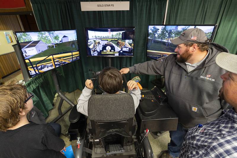 Jesse Sargeant takes the wheel Friday, Oct. 18, 2024, from a student trying out a tractor simulator at the Gold Star FS booth at SVCC. The school hosted the Pathways Playground, a day of career exploration by area eighth-graders.