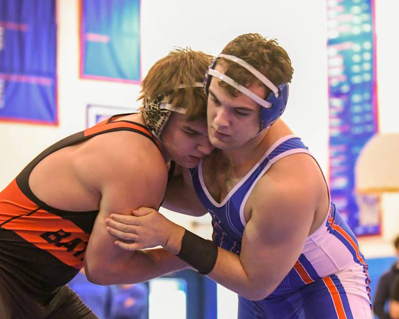 Batavia's Asher Sheldon, left, goes head to head with Marmion's Ed Perry during 220-pound championship match at Saturday's Class 3A Marmion Regional.