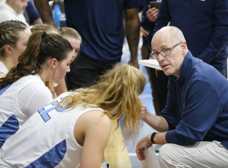 Nazareth coach Eddie Stritzel talks to the team during the girls varsity basketball game between Carmel High School and Nazareth Academy on Wednesday, Dec. 7, 2022 in LaGrange, IL.