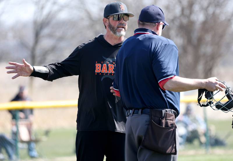DeKalb head coach Josh Latimer talks to the home plate umpire during their game Saturday, April 12, 2025, at Kaneland High School in Maple Park.