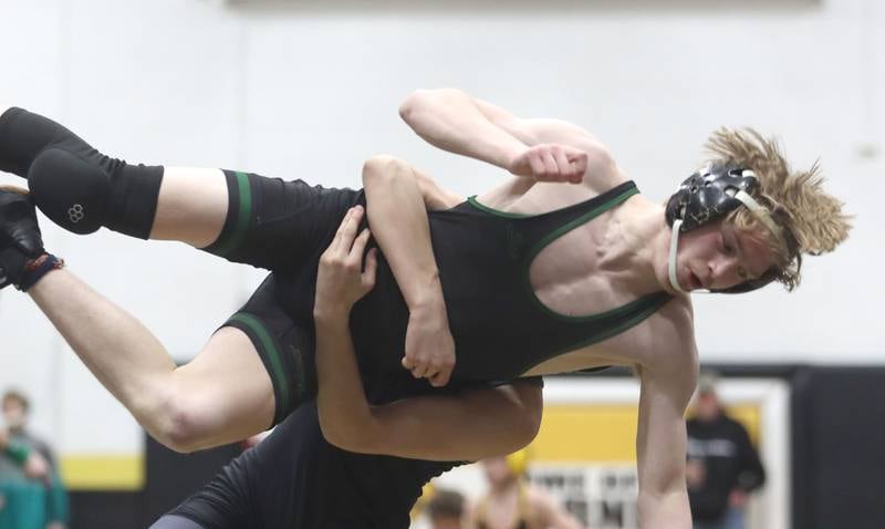 Christopher Talbert of Crystal Lake South is thrown by  Diego Martinez of Marian at 106 pounds in boys wrestling IHSA Class 2A Regional championship bout action on Saturday, Jan. 31, 2026, at Harvard High School in Harvard.