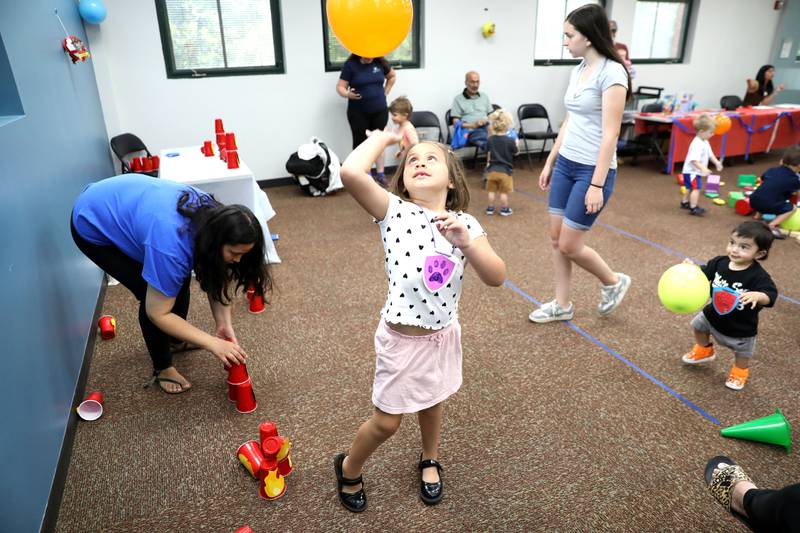 Josie Andrejevs, 5, of Downers Grove plays with a balloon during a Paw Patrol party at the Indian Prairie Public Library in Darien on Friday, June 28, 2024.