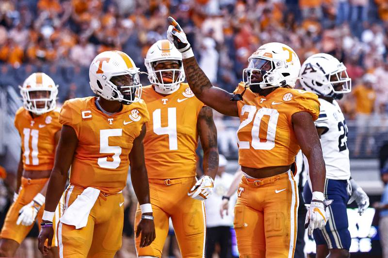 Tennessee running back Jaylen Wright (20) reacts to scoring a touchdown with quarterback Hendon Hooker (5), and wide receiver Cedric Tillman (4) during the first half of an NCAA college football game against Akron Saturday, Sept. 17, 2022, in Knoxville, Tenn. (AP Photo/Wade Payne)