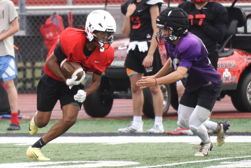Bradley-Bourbonnais' Rontez Smith, left, looks to evade Wilmington's Billy Moore during a joint summer workout at Bradley-Bourbonnais Wednesday, July 16, 2025.