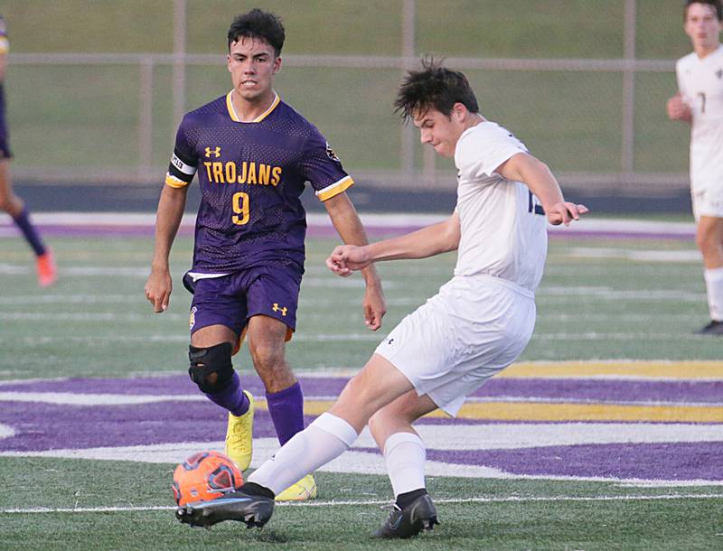 Bloomington Central Catholic's Jarrett Wieduwilt (13) kicks the ball in front of Mendota's Ricky Orozco (9) on Wednesday, Sept. 14, 2022 in Mendota.