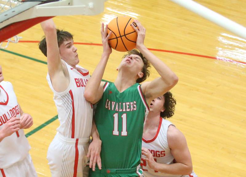 L-P's Jameson Hill gets sandwiched in the lane by Streator defenders Blaize Bressner and Jacob Hagle during the Class 3A Regional title game on Friday, Feb. 28, 2025 in Sellett Gymnasium at L-P High School.