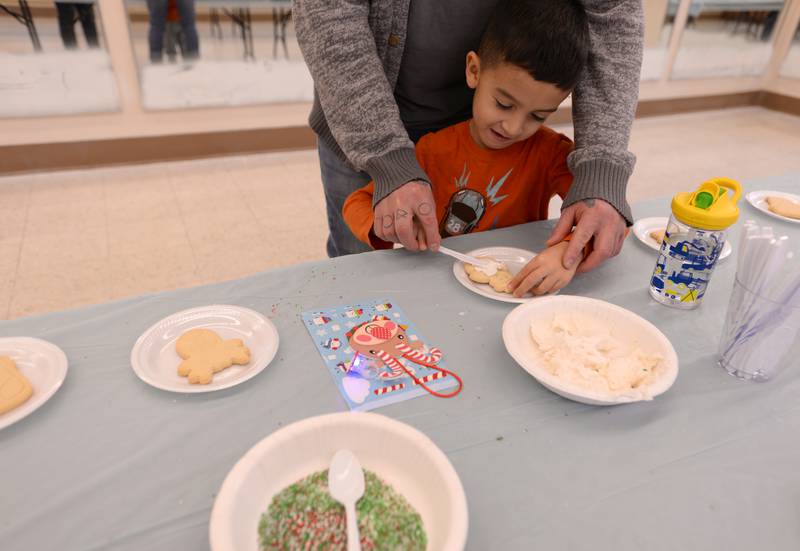 Children including Oliver Novak of Downers Grove decorate Christmas cookies while attending Downers Grove Park District's Candy Cane Lane Saturday, Dec. 2, 2023.