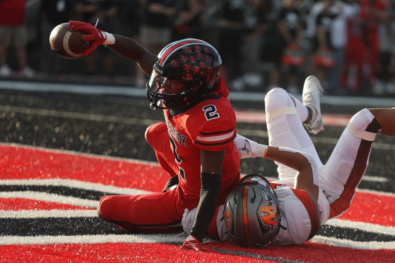 Bolingbrook’s Kyan Berry-Johnson falls in for the score against Minooka. Friday, Aug. 26, 2022, in Bolingbrook.