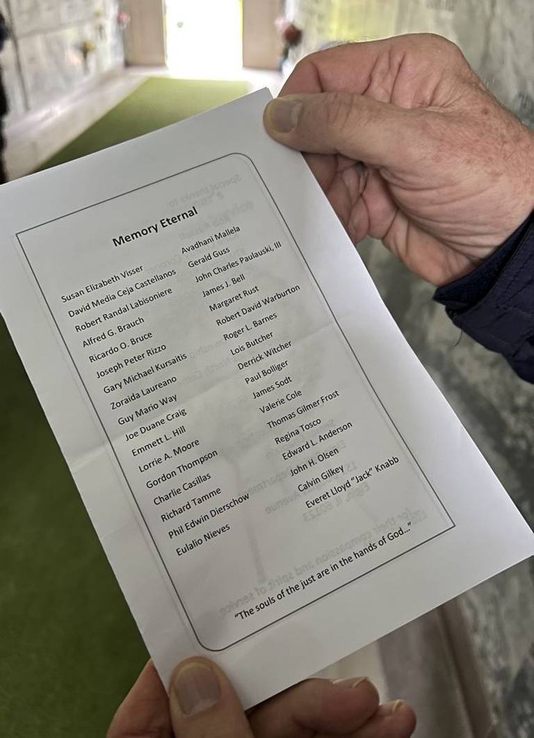 Names of unclaimed people are read at North Cemetery in St. Charles as part of the Kane County Coroner's Community Memorial Service on May 27, 2022.