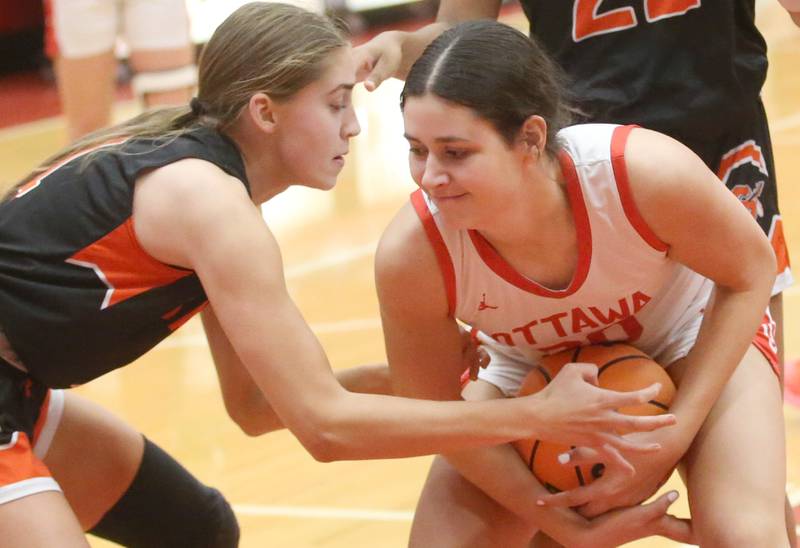 Ottawa's Bella Knoll keeps the ball away from Sandwich's Hannah Treptow on Monday, Jan. 27, 2025 in Kingman Gym at Ottawa High School.