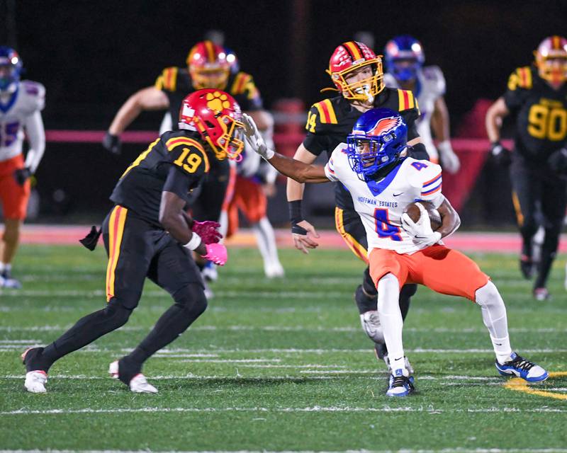 Hoffman Estates's Brandon Smith (4) tries to get around Batavia’s defender  Sai'mar Howell (19) during the first round of playoffs on Friday Oct. 31, 2025, held at Batavia High School.