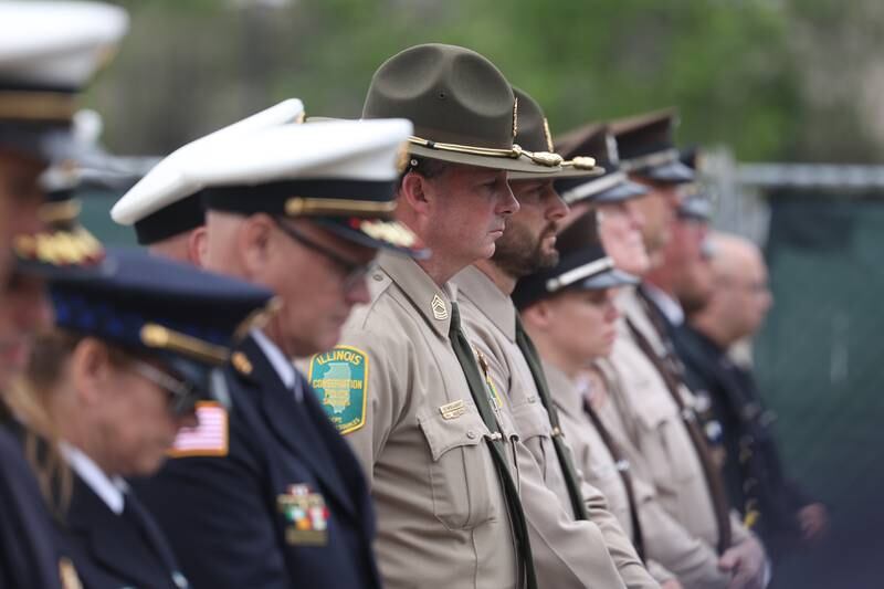 An officer with the Illinois Conservation Police stands with other law enforcement officers during the playing of Taps at the Will County Law Enforcement Memorial ceremony on Thursday, May 9, 2024 in downtown Joliet.