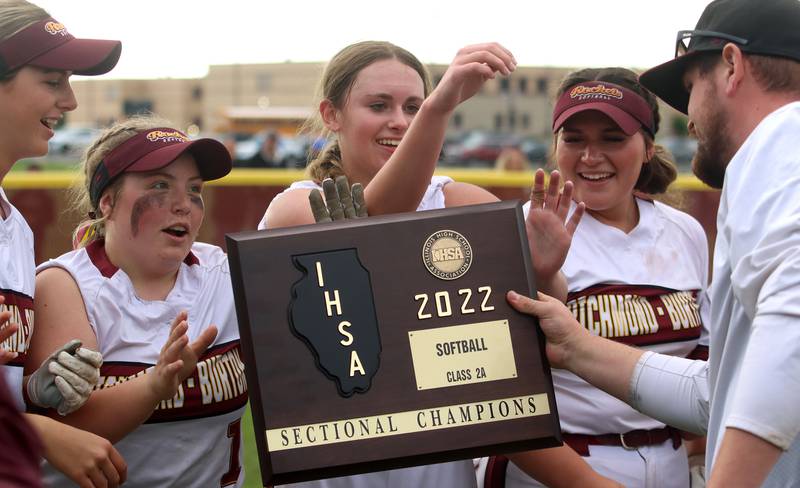 Richmond-Burton receives its hardware from coach Tylar Stanton, right, after a win over Stillman Valley in softball sectional title game action in Richmond Friday evening.
