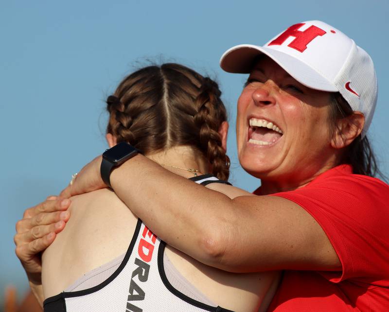 Huntley’s Addison Busam is greeted by coach Jennifer Garza, right, after the long jump  in IHSA Class 3A Girls Sectional Track and Field Meet action at Red Raider Stadium on the campus of Huntley High School in Huntley on Wednesday, May 14, 2025.