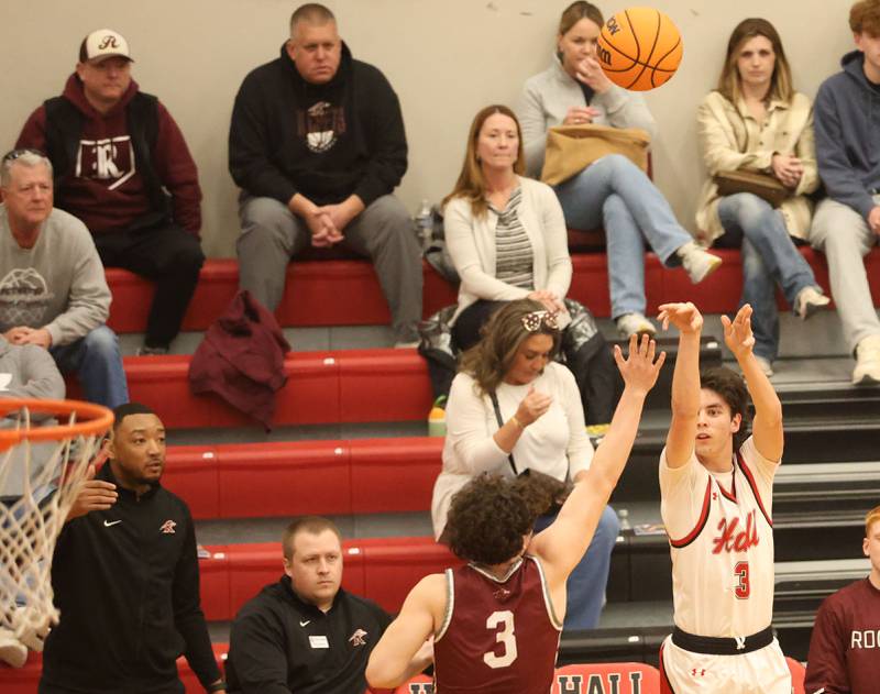 Hall's Noah Plym lets go of a three point basket over Rockridge's Kameron Wilkerson during the Class 2A Regional quarterfinal game on Monday, Feb. 23, 2026 at Hall High School.