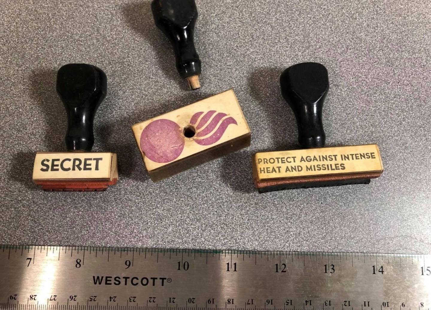 These stamps were nearly ubiquitous in all the offices at the Joliet Arsenal from 1940 to 1996. Midewin Nationall Tallgrass Prairie moved into old the old arsenal offices in the second half of the 1990s. Joe Wheeler, prairie archaeologist and heritage program manager for Midewin National Tallgrass Prairie, isn't certain where the "protect against intense heat and missiles” stamp was used. Wheeler said it could have been for documents but equally could have been for boxes of munitions or items that were munitions-related, although Wheeler feels the stamp is a little small for that purpose. The middle stamp is the “bursting bomb” symbol/logo for the U.S. Army Ordinance Department.