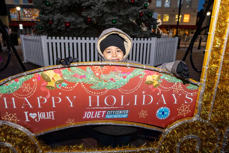 Armando Macejok, of Lockport, takes a photo before the Light Up the Holidays Tree Lighting Ceremony begins in Joliet’s City Square on Nov. 28, 2025.