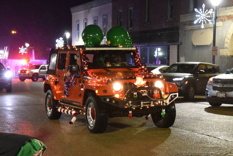 A decorated Jeep makes is way through downtown Mt. Morris during the Lighted Parade on Saturday, Dec. 2, 2023. The Jeeps in the parade carried toys for the Ogle County Toys for Tots in memory of Matt Wissmach.