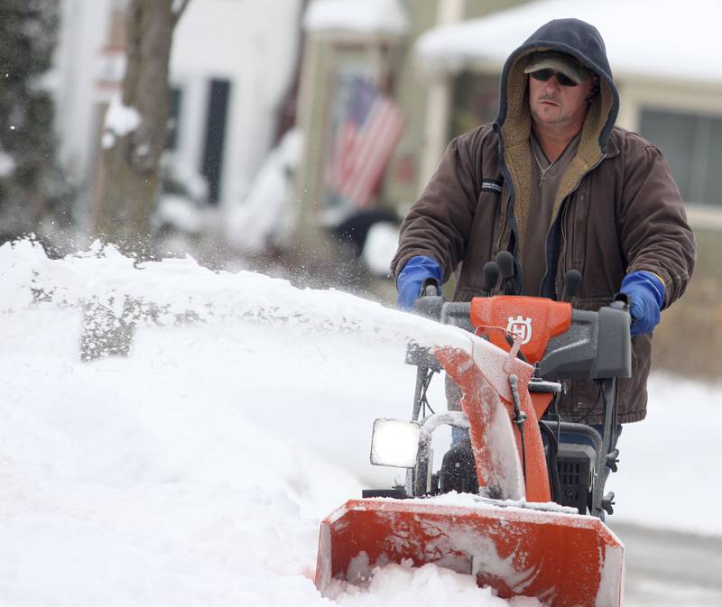 Carl Carlson clears snow near his Algonquin home on Sunday, Dec. 7, 2025.