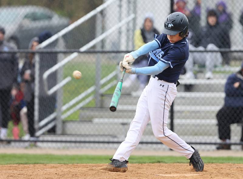 Downers Grove South's Wyatt Wawro (27) makes contact with the ball for a double during the varsity baseball game between Downers Grove South and Downers Grove North in Downers Grove on Saturday, April 29, 2023.