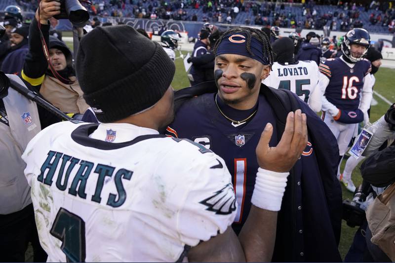 Chicago Bears quarterback Justin Fields (right) and Philadelphia Eagles quarterback Jalen Hurts meet after their teams' game on Dec. 18, 2022, in Chicago.