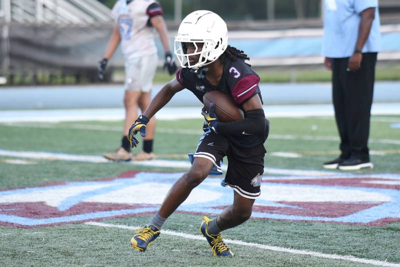 Kankakee's Cedric Terrell III runs after making a catch at practice Monday, Aug. 11, 2025.