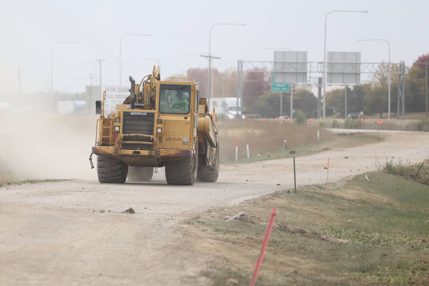 A construction truck drives along SE I-55 Frontage Road as groundwork continues on the Rock Run Crossings Development near the I-55 and I-80 interchange in Joliet on Tuesday, October 11th.