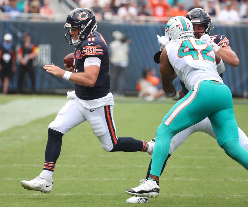 Chicago Bears quarterback Case Keenum is forced out of bounds by Miami Dolphins linebacker Grayson Murphy Sunday, Aug. 10, 2025, during their game at Soldier Field in Chicago.