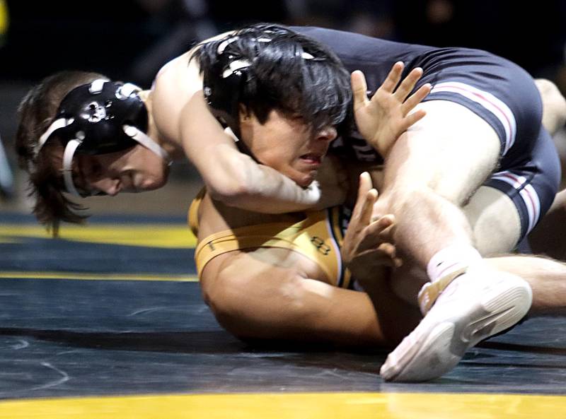 Prairie Ridge’s Tyler Evans, top, puts a finishing touch on his win against Crystal Lake South’s Zyon Schlee in a 132-pound bout in varsity wrestling at Crystal Lake South on Thursday.