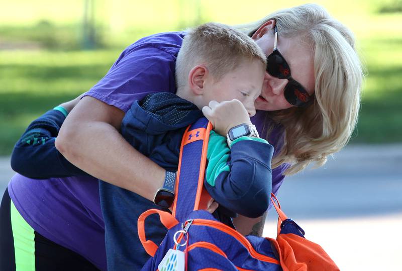 Megan Bacon says goodbye to her son Brantley on his first day of third grade Tuesday, Aug. 16, 2022, on opening day at Genoa Elementary School.