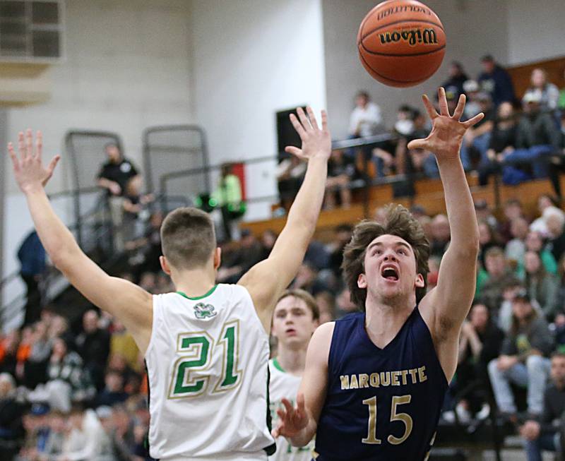 Marquette's Tommy Durdan runs around Seneca's Lane Provance to score a basket during the Tri-County Conference Tournament championship game on Friday, Jan. 27, 2023, at Putnam County High School.