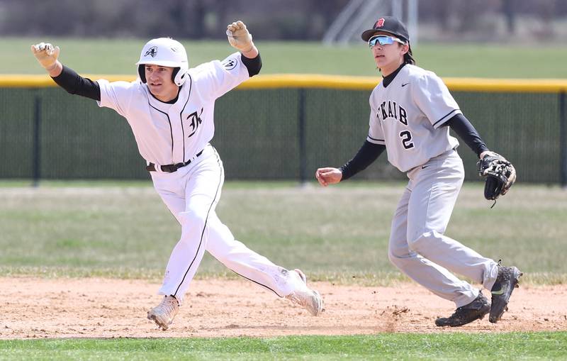 Kaneland's Alex Panico gets a secondary lead as DeKalb's Nathaniel Nunez holds him on during their game Friday, April 15, 2022, at Kaneland High School in Maple Park.