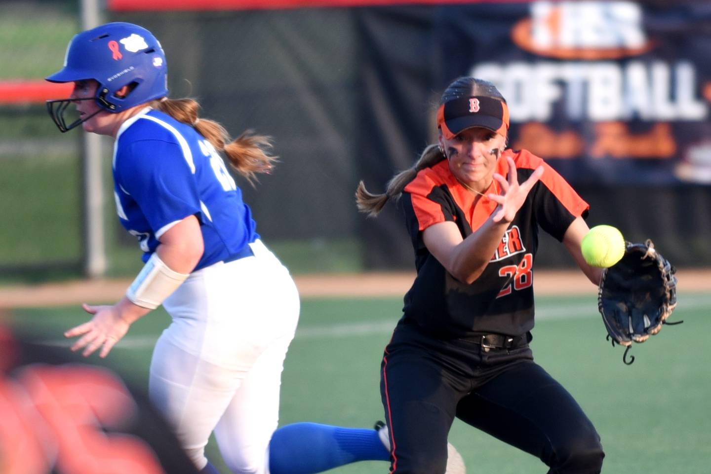 Beecher's Ava Olson, right, attempts to field a ball as Auburn's Skylar Meats runs towards third base during the Class 2A State semifinals at the Louisville Slugger Complex in Peoria Friday, June 6, 2025.