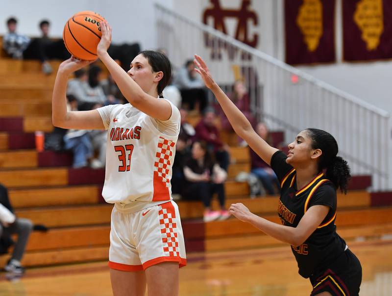 Minooka’s Clare O'Brien (33) shoots as Montini’s Nathalia Richardson defends during a Montini Christmas Tournament game on December 22, 2025 at Montini Catholic High School in Lombard.